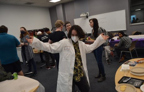 Photo of person in lab coat at a social event